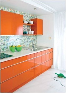 białe ściany i pomarańczowe meble w kuchni